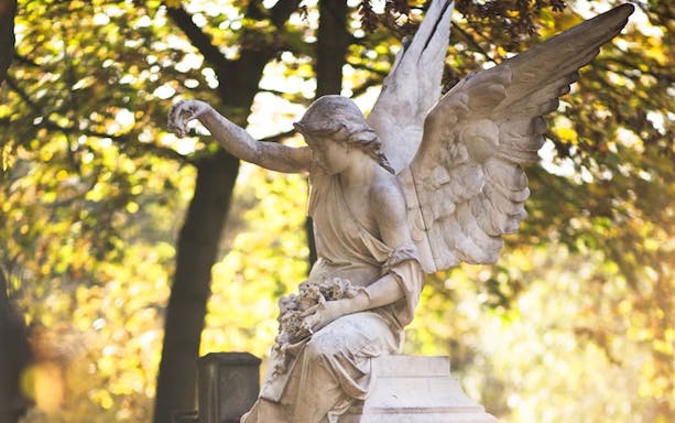 Angel statue in Père Lachaise Cemetery during walking tour, Paris.