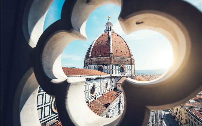 Brunelleschi’s Dome viewed through a decorative window in Florence, Italy.