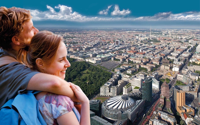 Couple enjoying city view from Panoramapunkt Berlin with skyline and Sony Center.