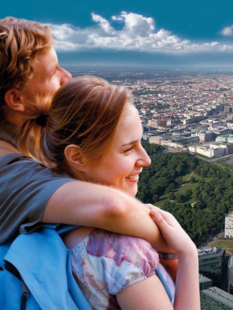 Couple enjoying city view from Panoramapunkt Berlin with skyline and Sony Center.
