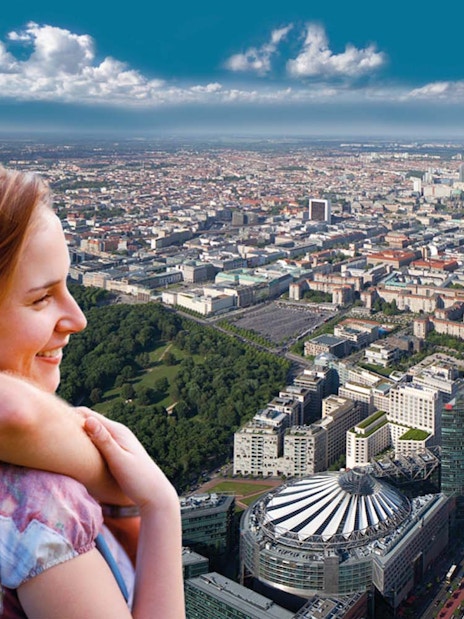 Couple enjoying city view from Panoramapunkt Berlin with skyline and Sony Center.