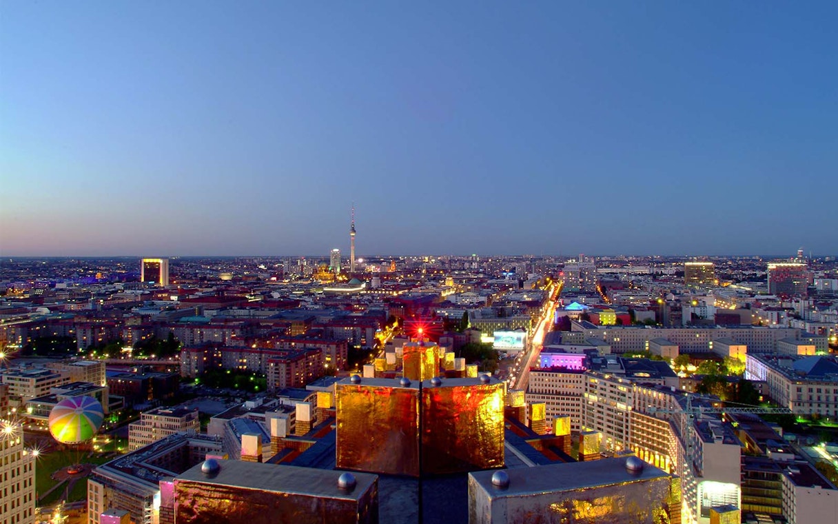 Berlin cityscape view from Panoramapunkt at dusk, featuring the TV Tower and illuminated streets.