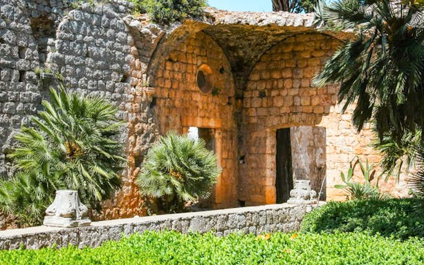 Ancient stone walls and lush greenery on Lokrum Island, Dubrovnik, featured in Game of Thrones.