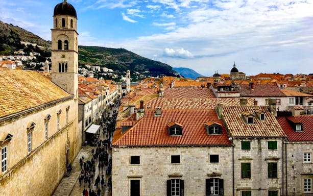 Old Town Dubrovnik rooftops and bell tower with Stradun street below, Croatia.