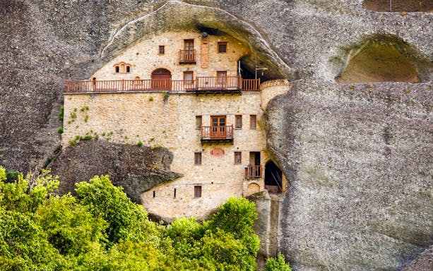 Monastery built into rock face, Meteora Sightseeing Tour, Greece.