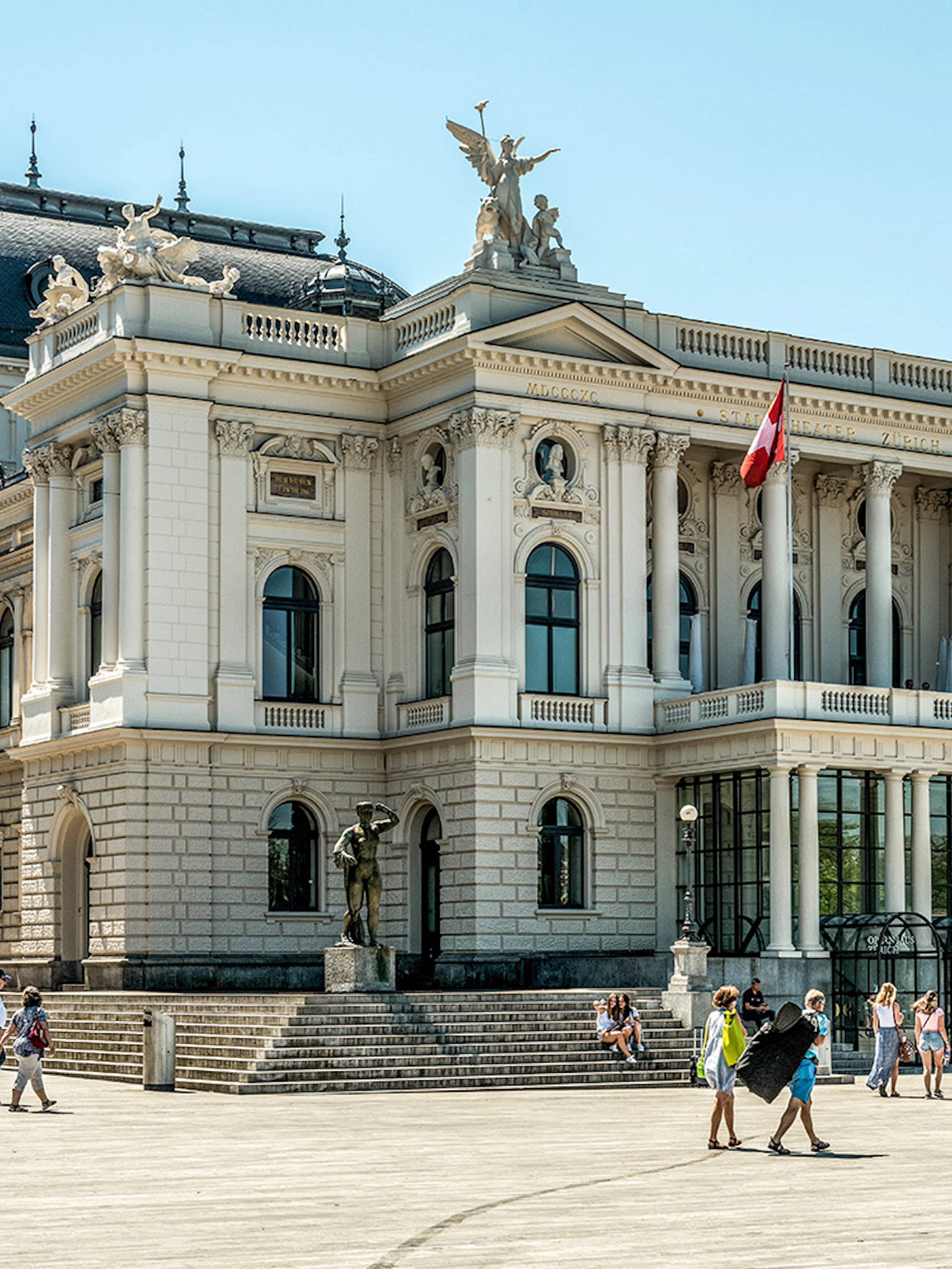 Zurich Opera House with visitors in the plaza, part of The ZURICH Experience Tour.