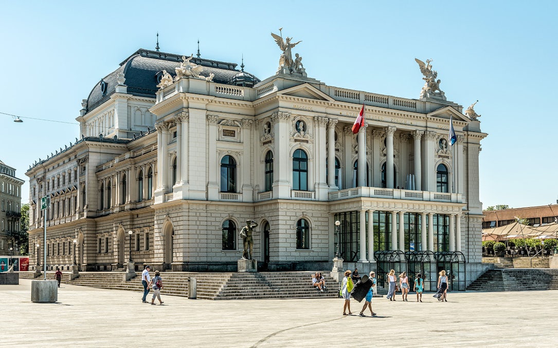 Zurich Opera House with visitors in the plaza, part of The ZURICH Experience Tour.