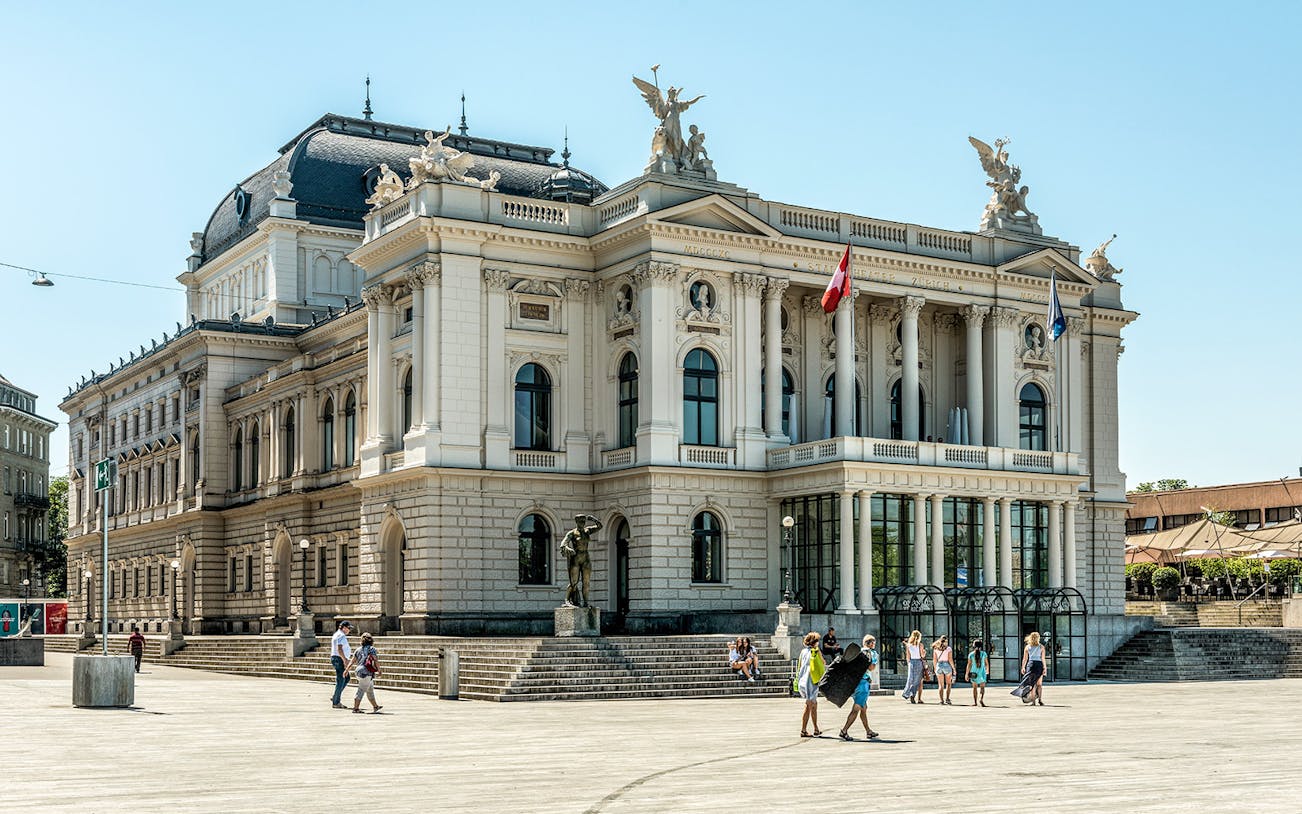 Zurich Opera House with visitors in the plaza, part of The ZURICH Experience Tour.