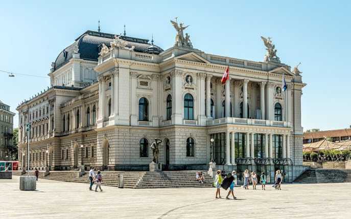 Zurich Opera House with visitors in the plaza, part of The ZURICH Experience Tour.