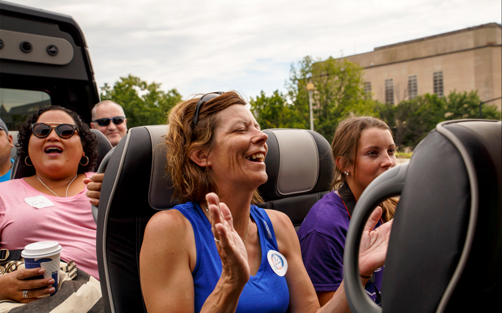 People on the upper deck of Hop On Hop Off Bus