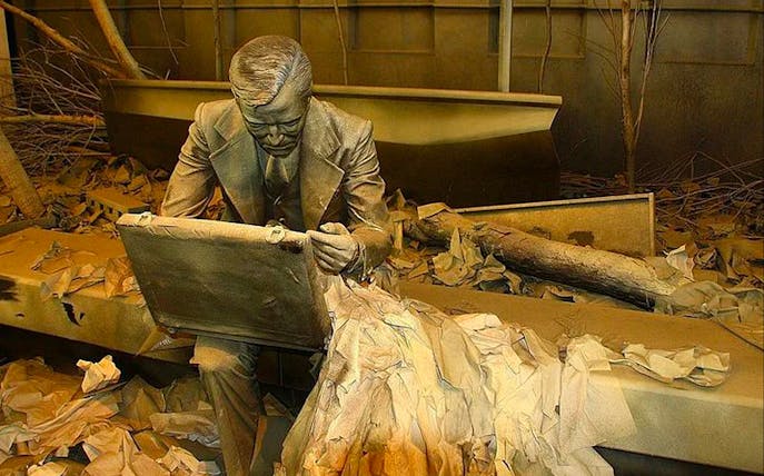 Sculpture of a man with a briefcase at Ground Zero 911 Memorial, New York City.
