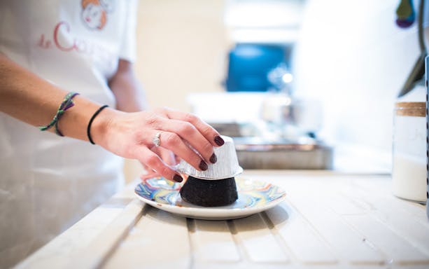 Hand preparing dessert in private cooking class, Bologna.