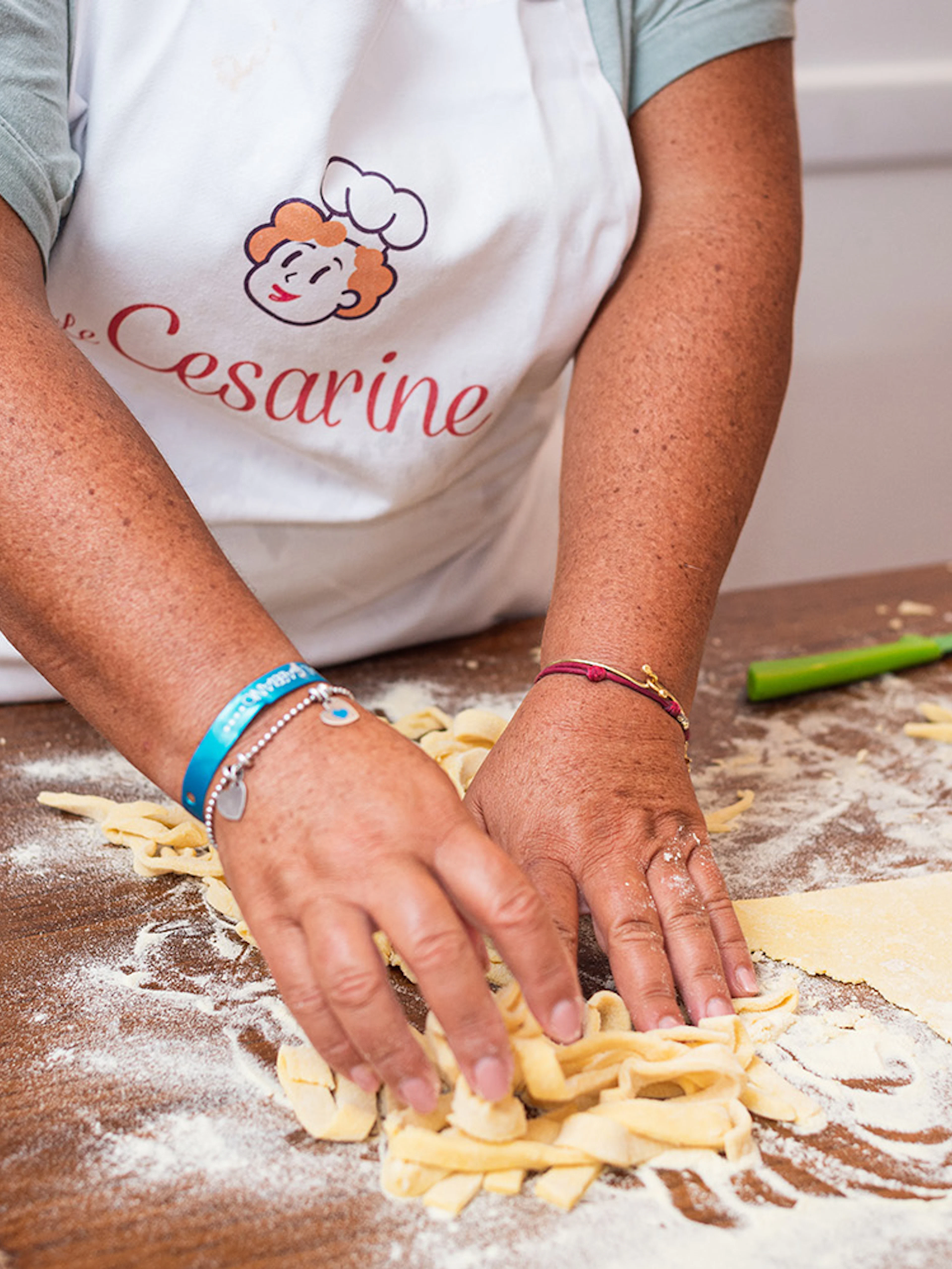Hands making pasta during a private cooking class in Rome.