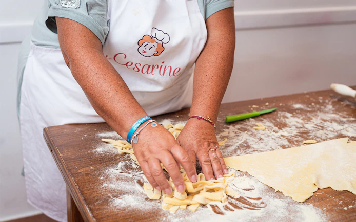 Hands making pasta during a private cooking class in Rome.