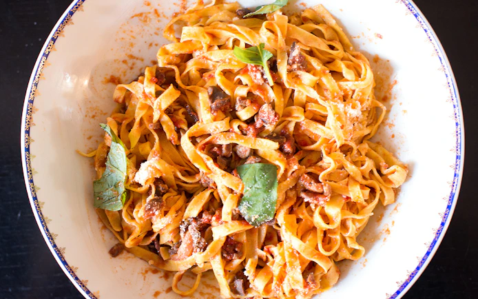Fresh pasta with tomato sauce and basil from a private cooking class in Rome.