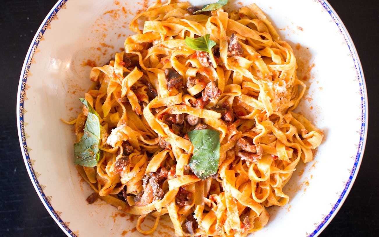 Fresh pasta with tomato sauce and basil from a private cooking class in Rome.