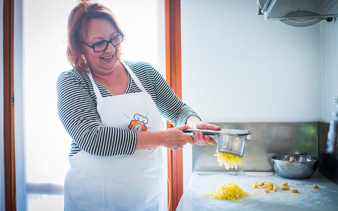 Woman preparing pasta dough in a private cooking class in Milan.