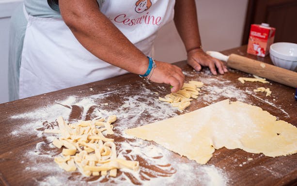 Person preparing fresh pasta during a private cooking class in Milan.