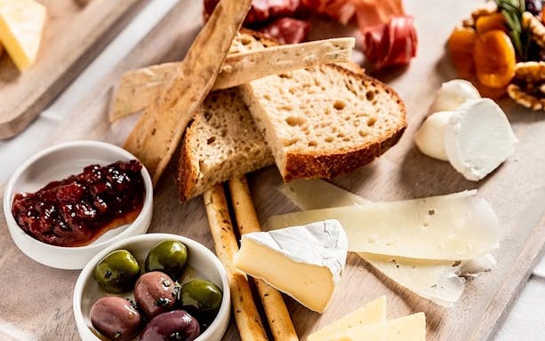 Cheese and bread platter with olives and jam, part of Harbour Experience tour.