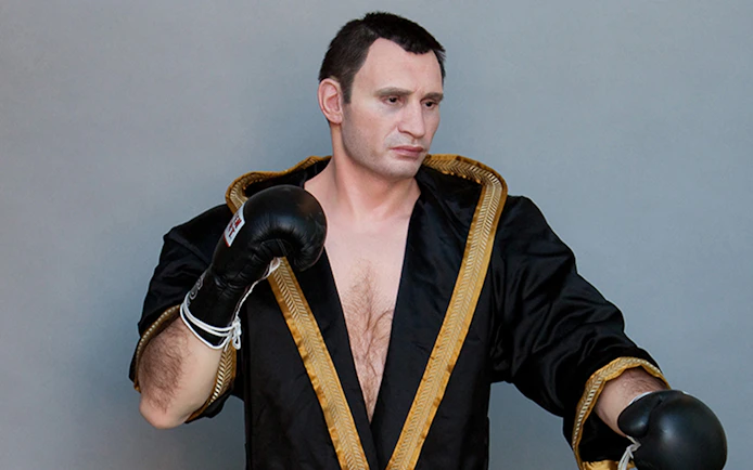 Wax figure of a boxer in black robe at Panoptikum - Das Wachsfigurenkabinett.