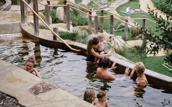Visitors enjoying a soak in the Peninsula Hot Springs pool.