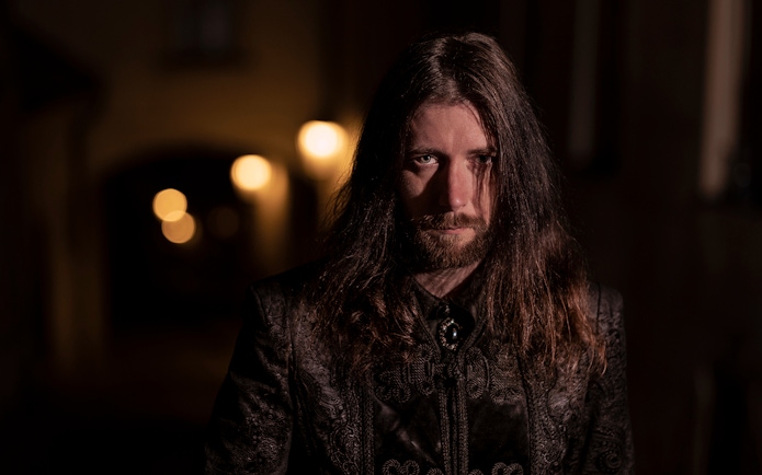 Guide in dark alley during Prague's Old Town ghost tour.