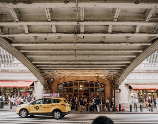 Grand Central Terminal exterior with people on walking tour in New York City.