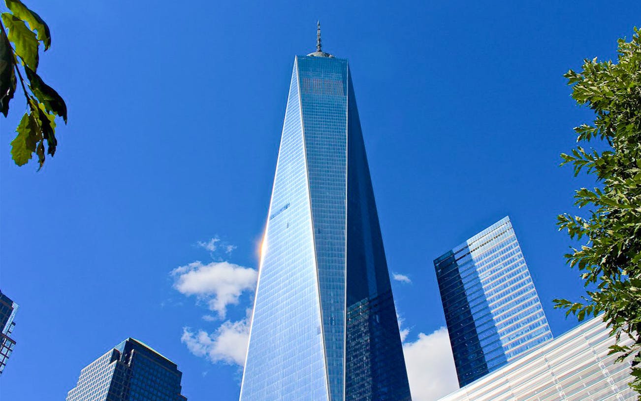 One World Trade Center against a clear blue sky in New York City.