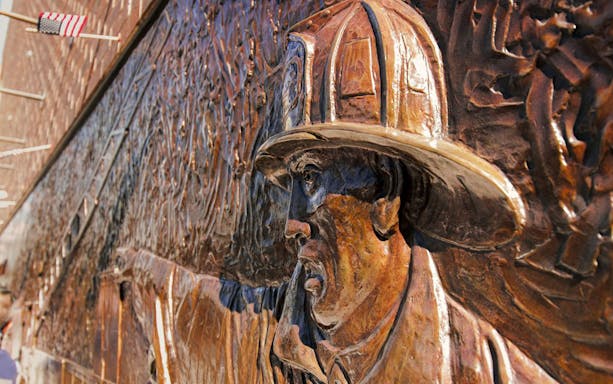 Firefighter memorial sculpture at 9/11 Memorial, New York City.