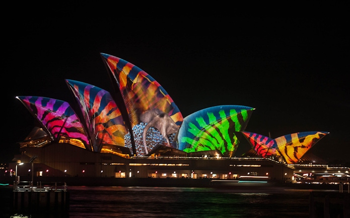 Sydney Opera House illuminated with colorful patterns during Vivid 2022 Cruise.