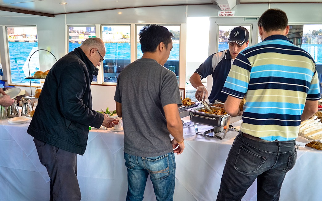 Guests enjoying a buffet on a Sydney Whale Watching Cruise.