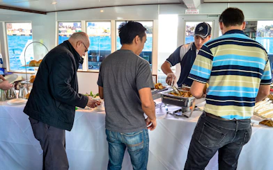Guests enjoying a buffet on a Sydney Whale Watching Cruise.