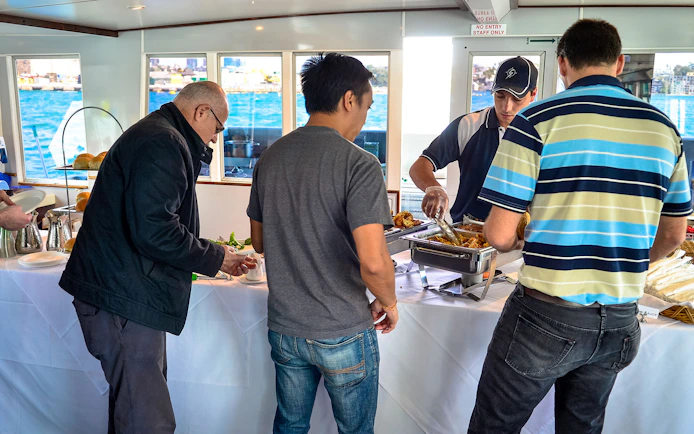Guests enjoying a buffet on a Sydney Whale Watching Cruise.