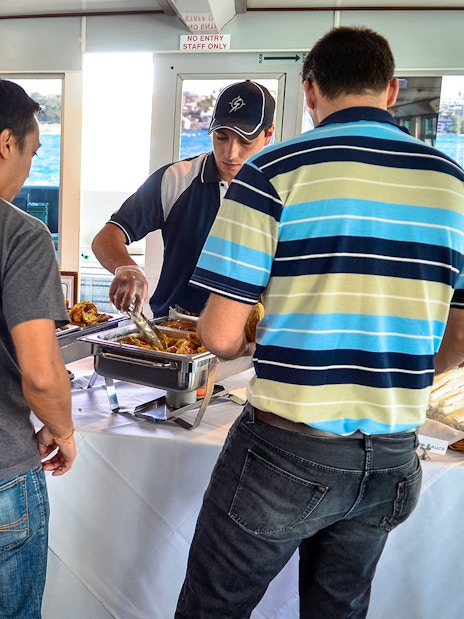 Guests enjoying a buffet on a Sydney Whale Watching Cruise.