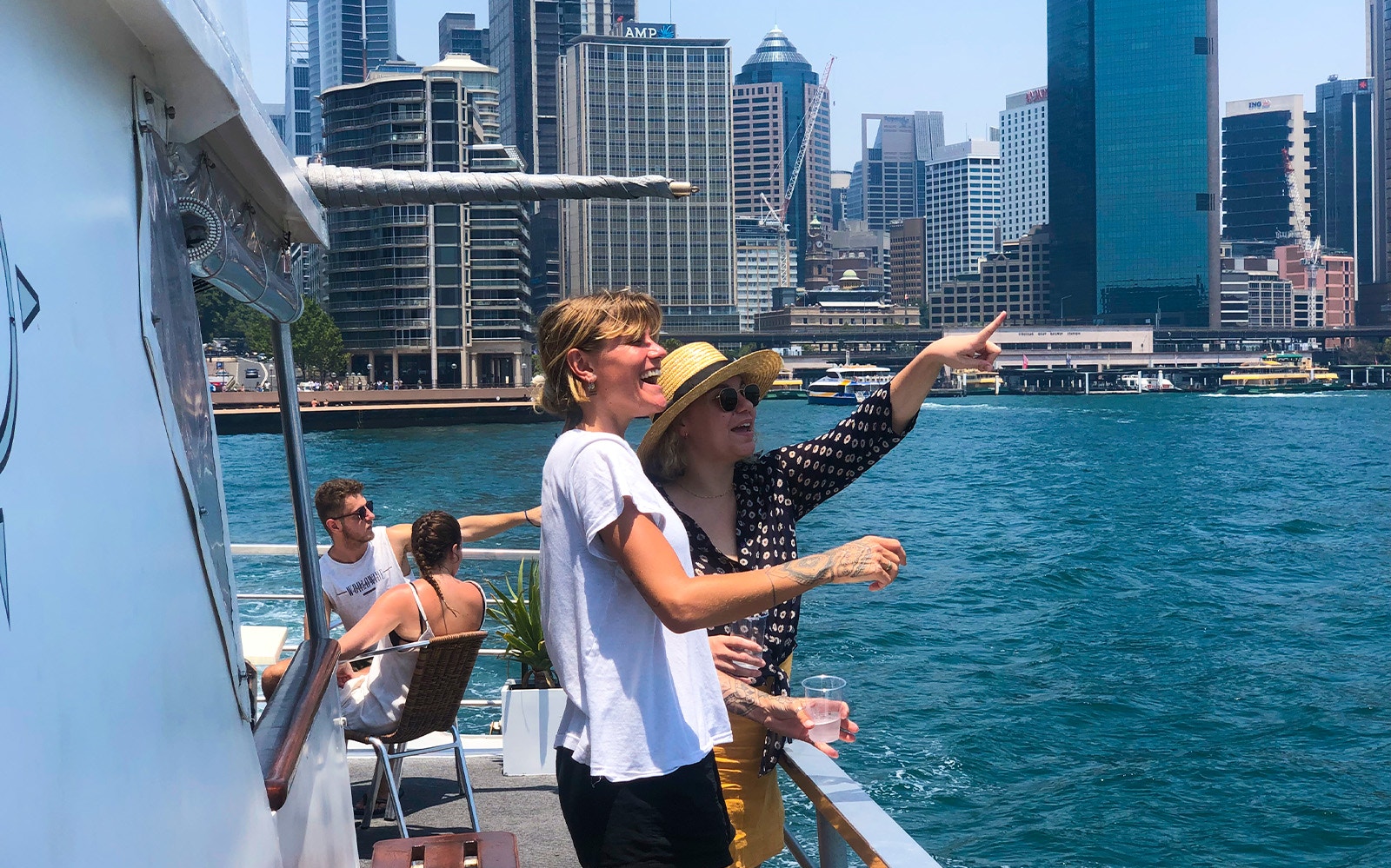 Sydney Harbour cruise ship with passengers enjoying buffet lunch, iconic Sydney Opera House in background.