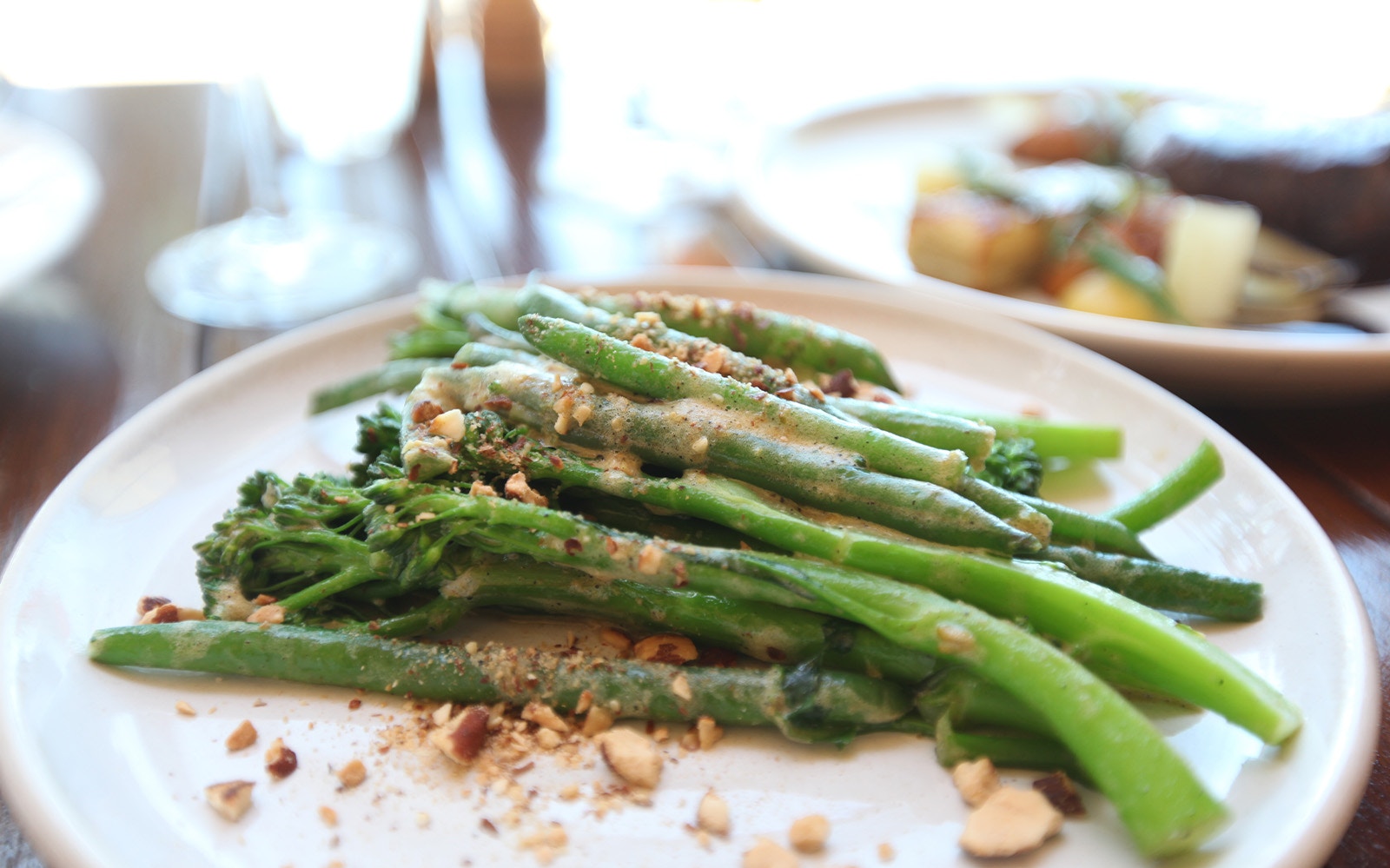 Steamed green vegetables with nuts served on Sydney Harbour Long Lunch Cruise.