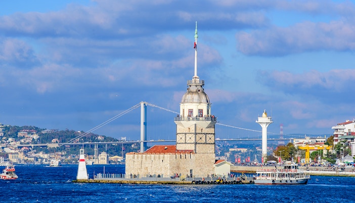 Bosphorus cruise ship sailing past Istanbul's historic skyline with iconic landmarks.