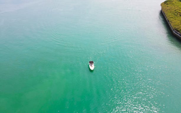 Boat cruising on turquoise water during Seafarer's Channel Tour.