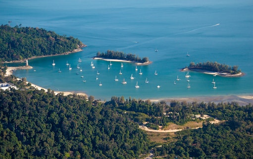 Aerial view of Langkawi Island with yachts in the bay during a helicopter tour.
