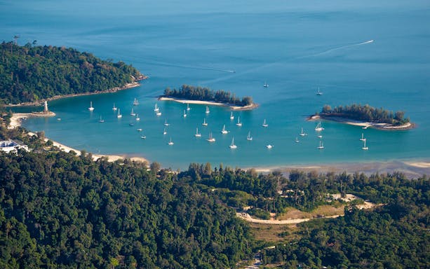 Aerial view of Langkawi Island with yachts in the bay during a helicopter tour.