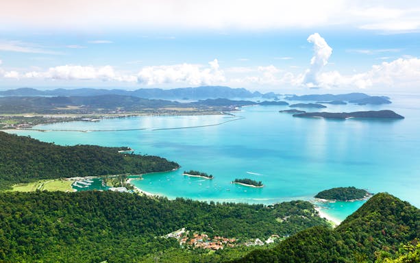 Aerial view of Langkawi Island's coastline and lush greenery during a helicopter tour.