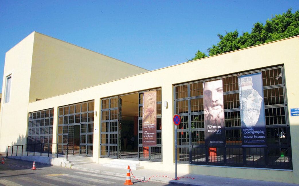 Heraklion Archaeological Museum entrance with banners displaying ancient artifacts.