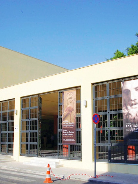 Heraklion Archaeological Museum entrance with banners displaying ancient artifacts.