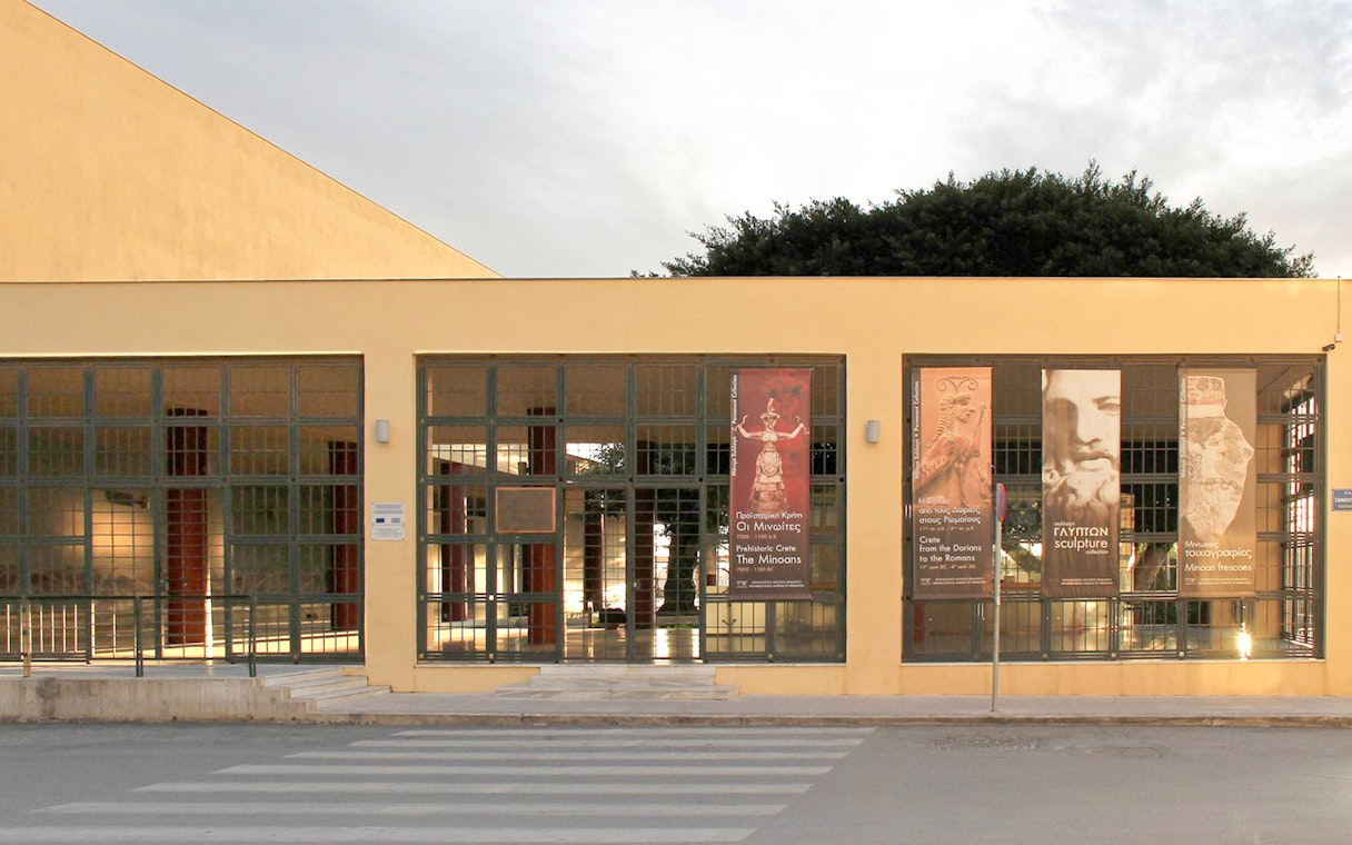 Heraklion Archaeological Museum entrance with banners displaying ancient artifacts.