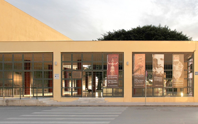 Heraklion Archaeological Museum entrance with banners displaying ancient artifacts.