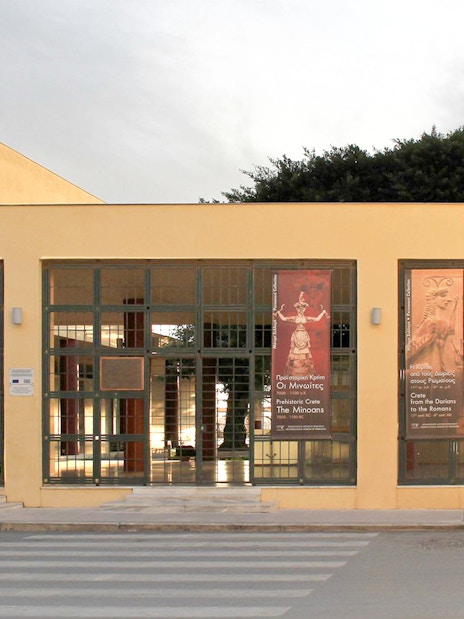 Heraklion Archaeological Museum entrance with banners displaying ancient artifacts.