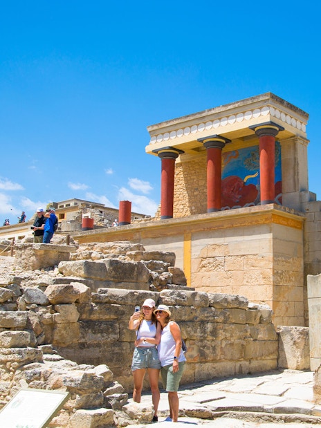 Guests exploring the ancient ruins of Knossos Palace in Crete.