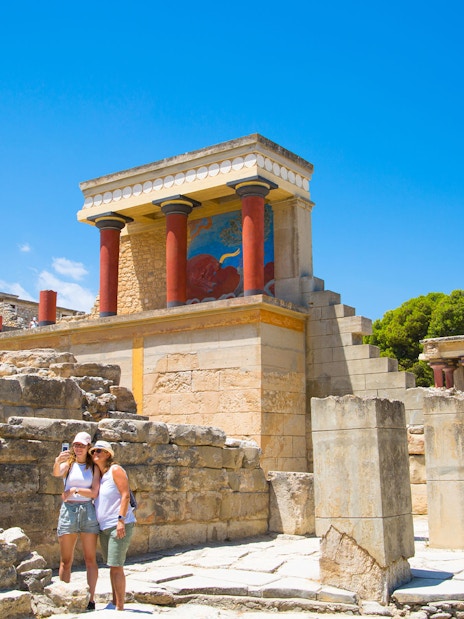 Guests exploring the ancient ruins of Knossos Palace in Crete.