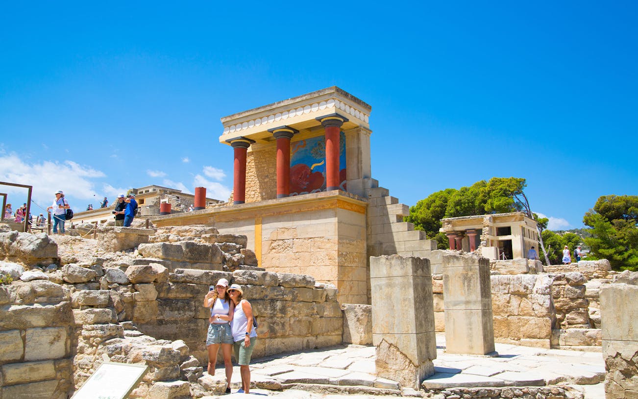 Guests exploring the ancient ruins of Knossos Palace in Crete.