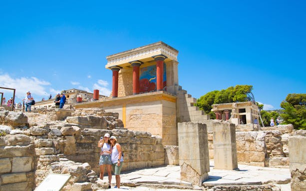 Guests exploring the ancient ruins of Knossos Palace in Crete.